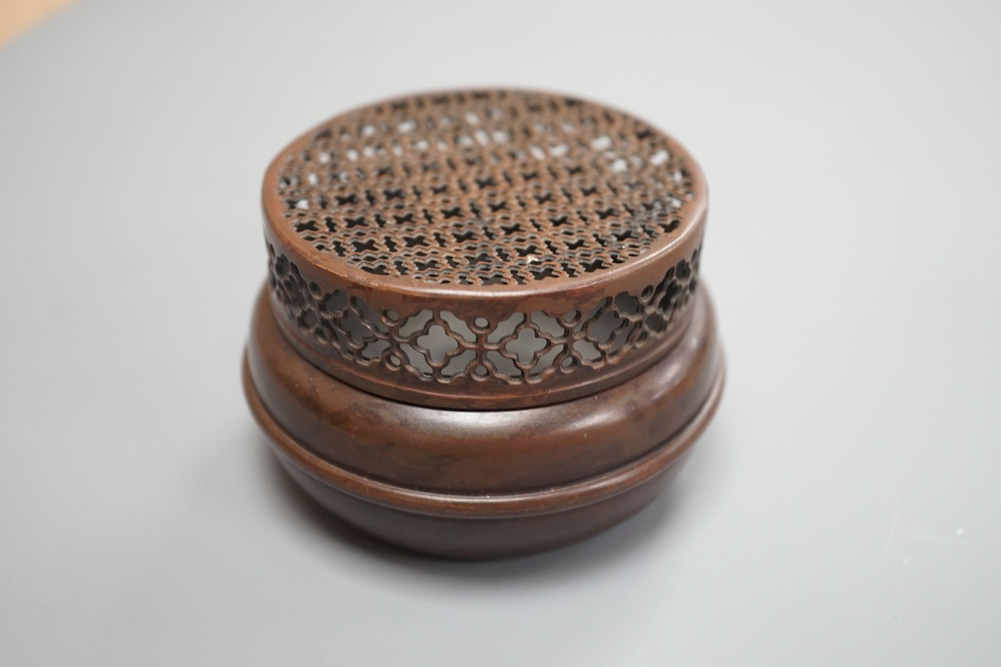 A Chinese bronze hand warmer, signed Zhang Mingqi 8cm diameter